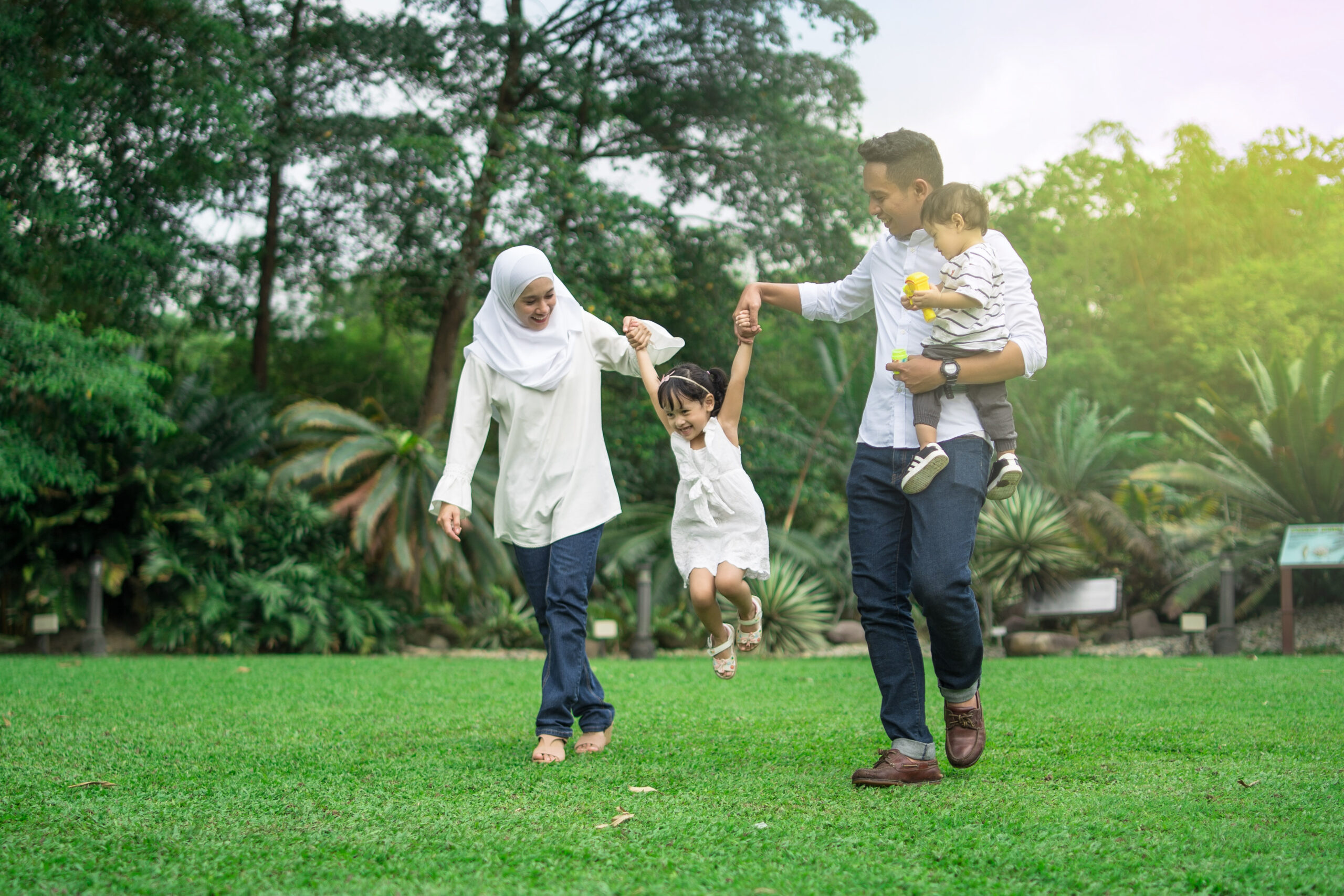 malay family having quality time in a park with morning mood